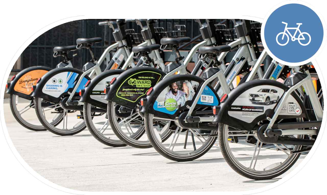 A collection of e-bikes docked at a docking station