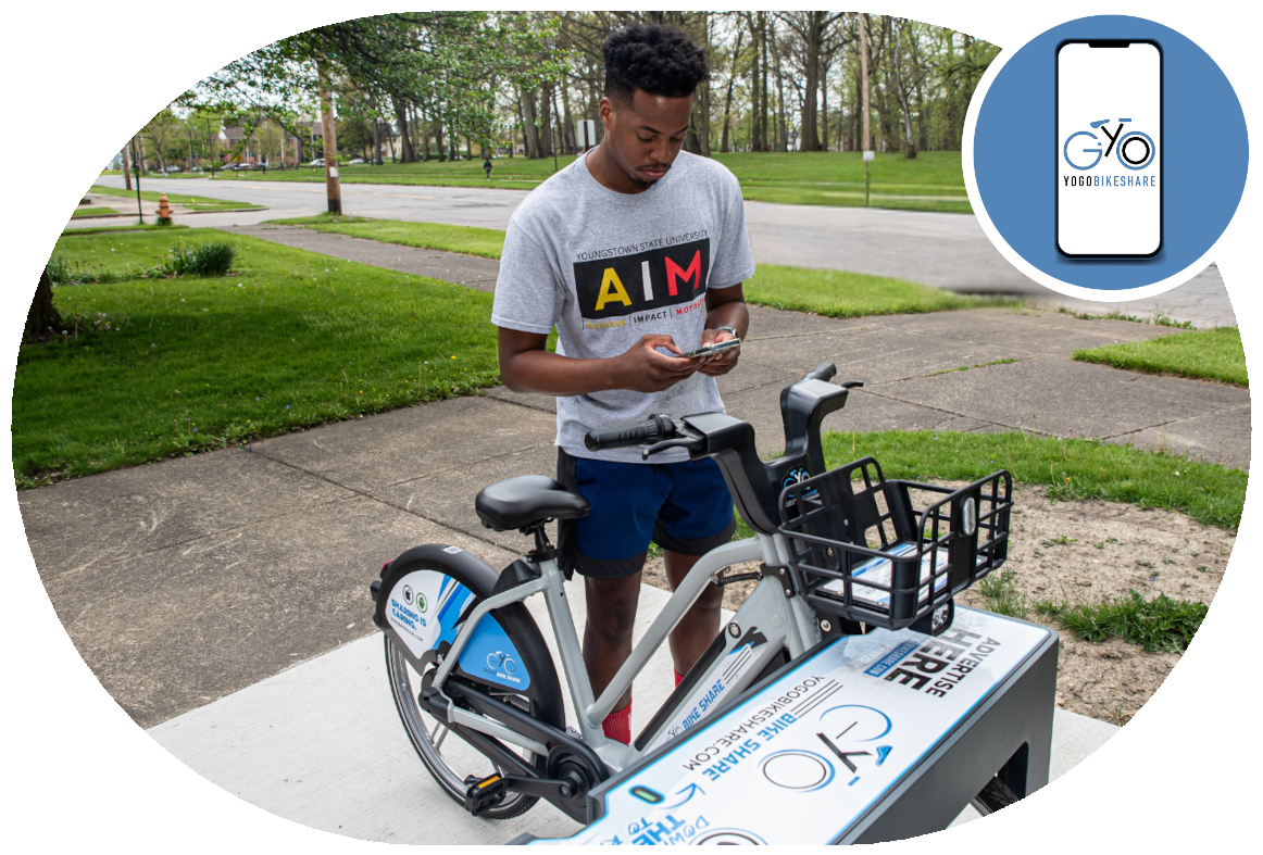 A young African American bicyclist using their phone to checkout an e-bike